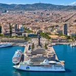 Aerial view of Barcelona cruise port with cruise ships and the city skyline.
