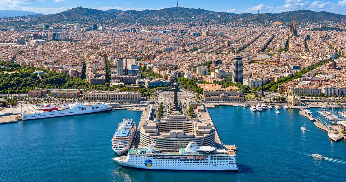 Aerial view of Barcelona cruise port with cruise ships and the city skyline.