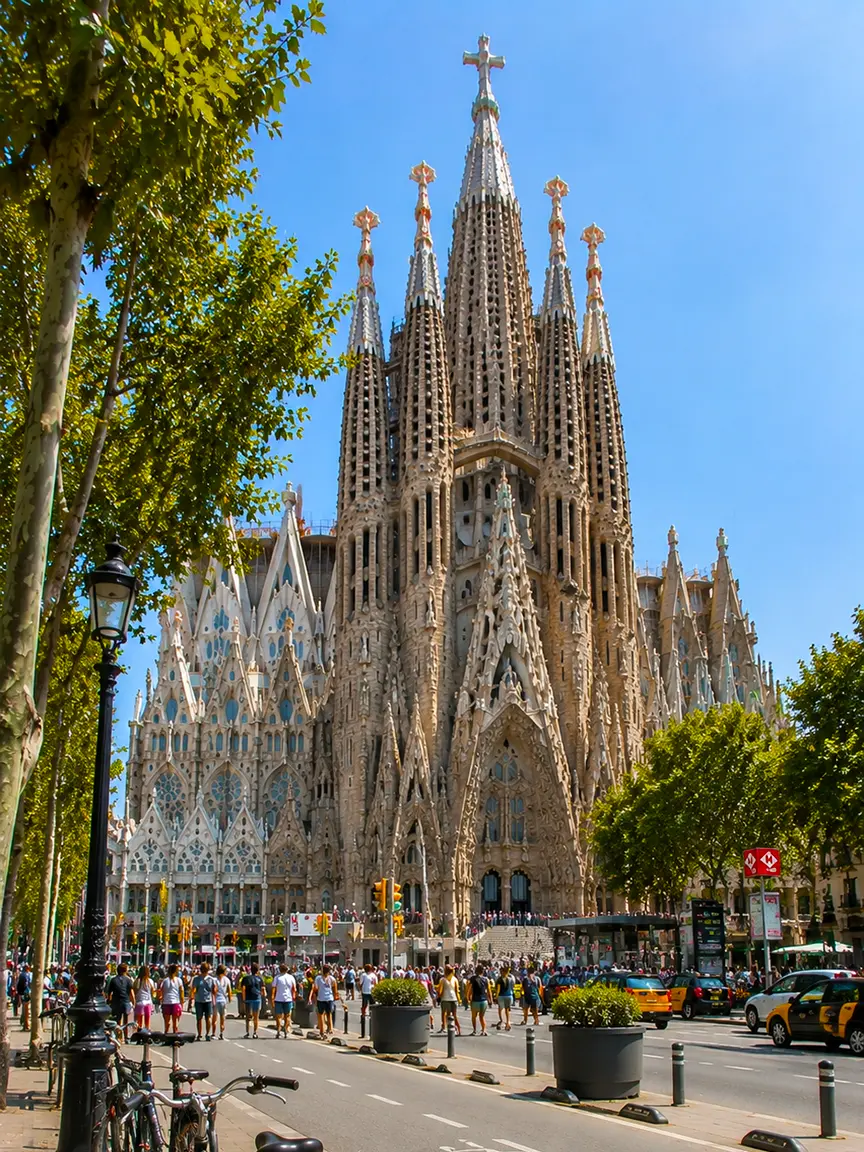 Iconic view of the Sagrada Familia basilica bathed in bright sunlight during Sant Joan Festival 2026, with crowds of visitors, taxis, and lush green trees in the foreground.